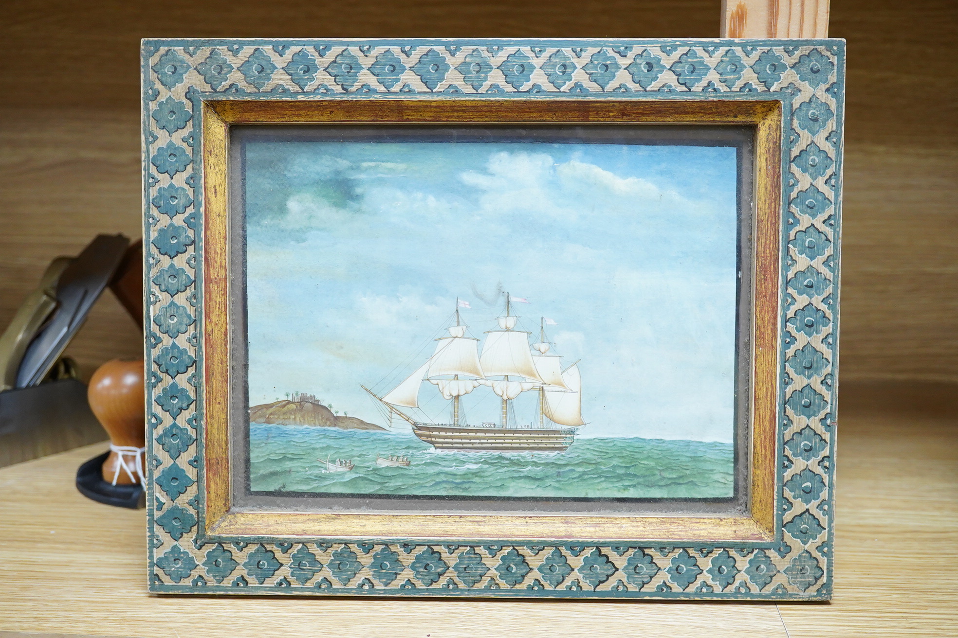 Late 19th / early 20th century School, English frigate in full sail off the coast, watercolour, heightened with white, housed in a painted frame, 15 x 20cm